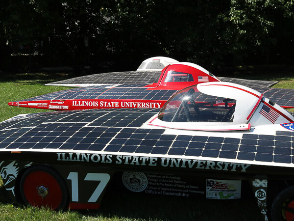 Solar-powered cars displaying Illinois State University branding with solar panels.