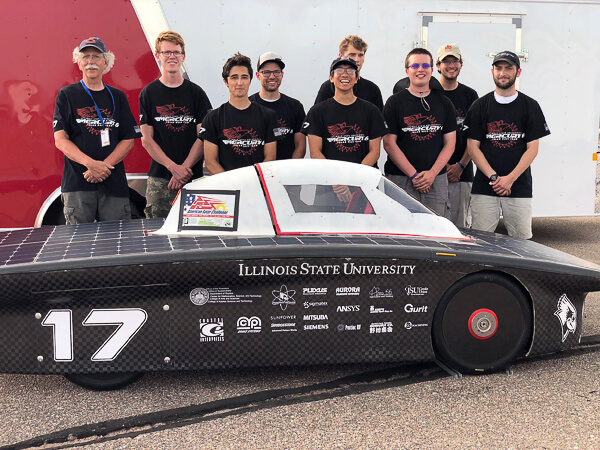 A team stands behind a solar car marked with "17" and "Illinois State University."